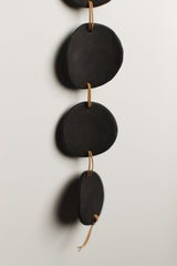 Hand-pinched black porcelain circles with leather cord