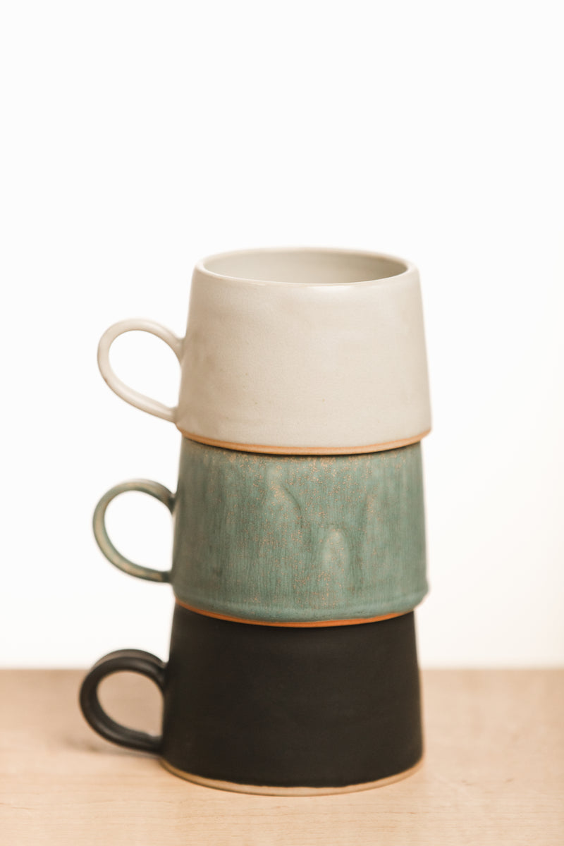White, turquoise and black mugs